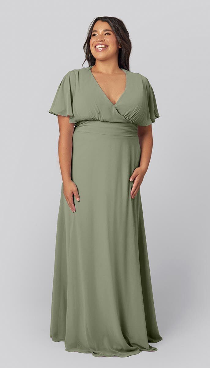Model wears a moss-colored gown with fluttering sleeves. 
