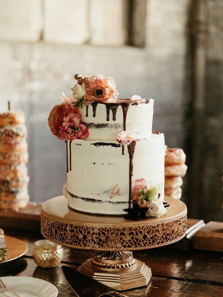 two-tier buttercream fall wedding cake with chocolate drip icing and pink and orange flowers