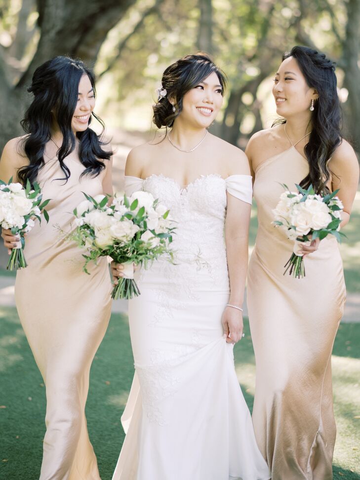 Bride in Off-the-Shoulder Wedding Dress With Bridesmaids in Gold Dresses