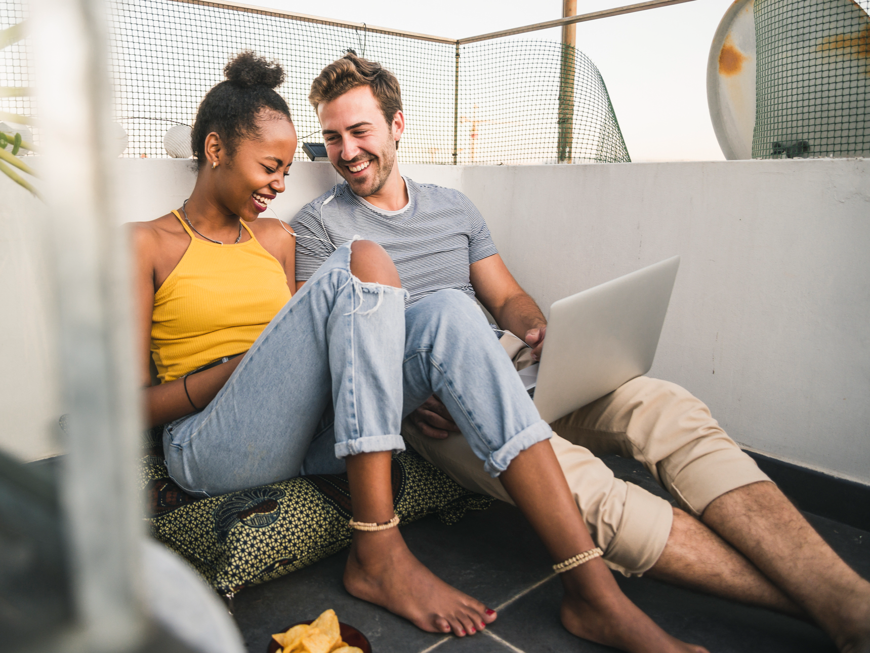 Couple listening to music on laptop