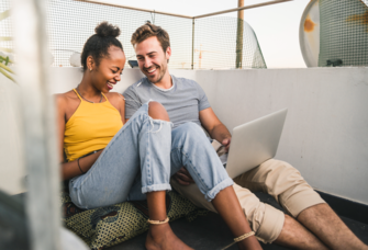 Couple listening to music on laptop