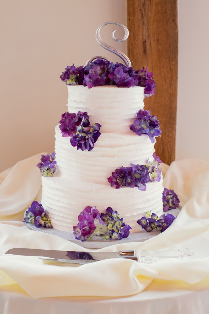 Dice's Creative Cakes baked a three-tier white confection for the couple that complemented their whimsical centerpieces. Once again putting a fun twist on their formal wedding, Sarah and Matt had purple hydrangeas placed on each tier and topped the dessert with a fun silver “S.” “Speaking of cakes, as a surprise for Matt I had a groom's cake made in the shape of an Xbox, which he enjoys playing in his free time,” Sarah says.