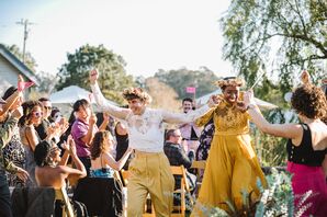 Newlyweds in Unique, Yellow Outfits and Flower Crowns During Recessional