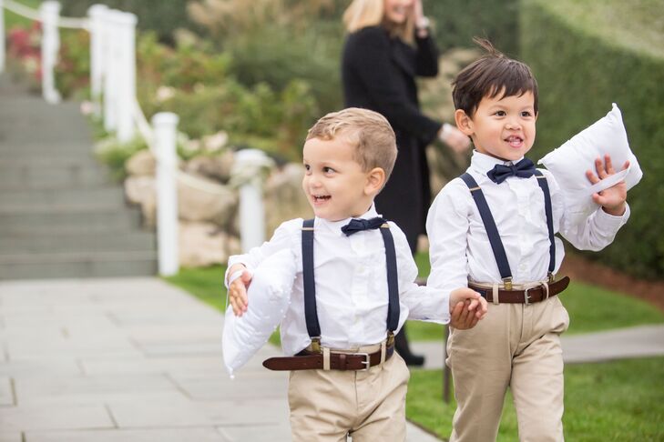 The ring bearers looked smart in their matching ensembles, the combination of khaki trousers, white button-down shirts, bowties and suspenders complementing the wedding's preppy vibe.
