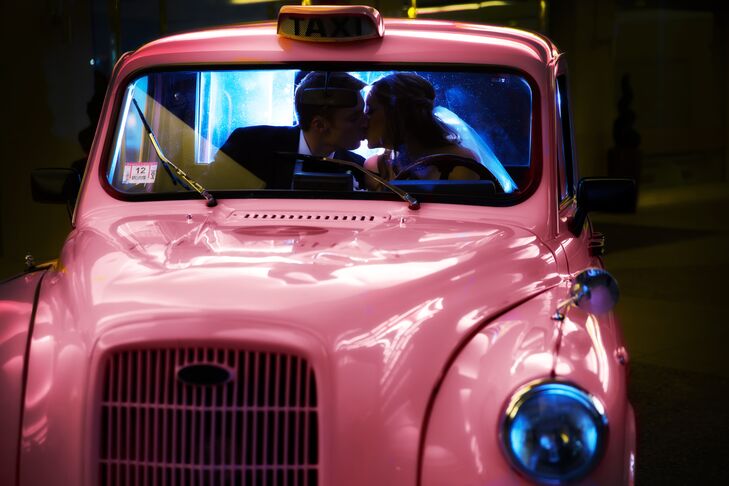 The couple shared a kiss inside a vintage pink taxi cab.