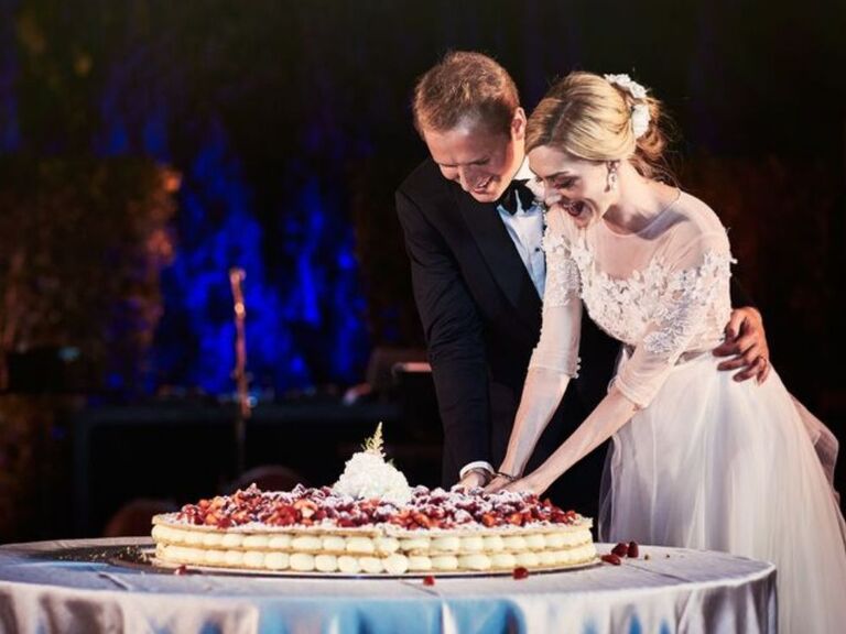 couple cutting into Italian wedding cake