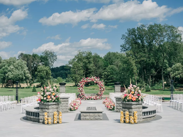 A circular floral wedding arch is ideal for a whimsical modern wedding.