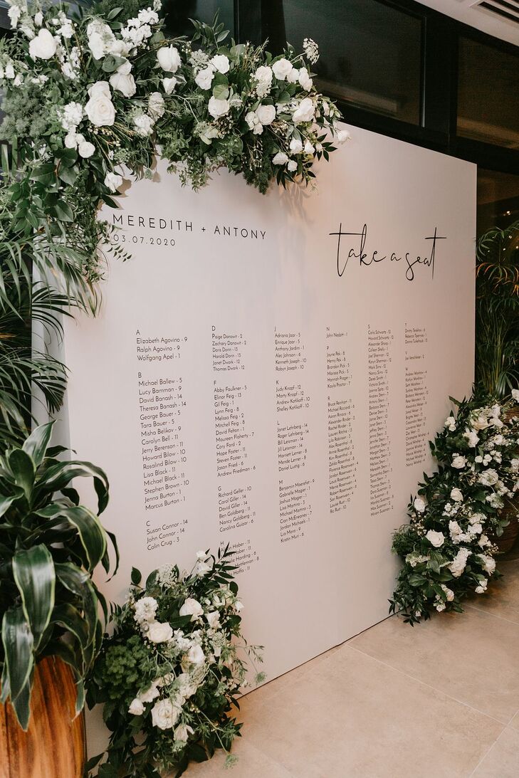 Modern Wall-Mounted Seating Chart with Greenery and White Roses