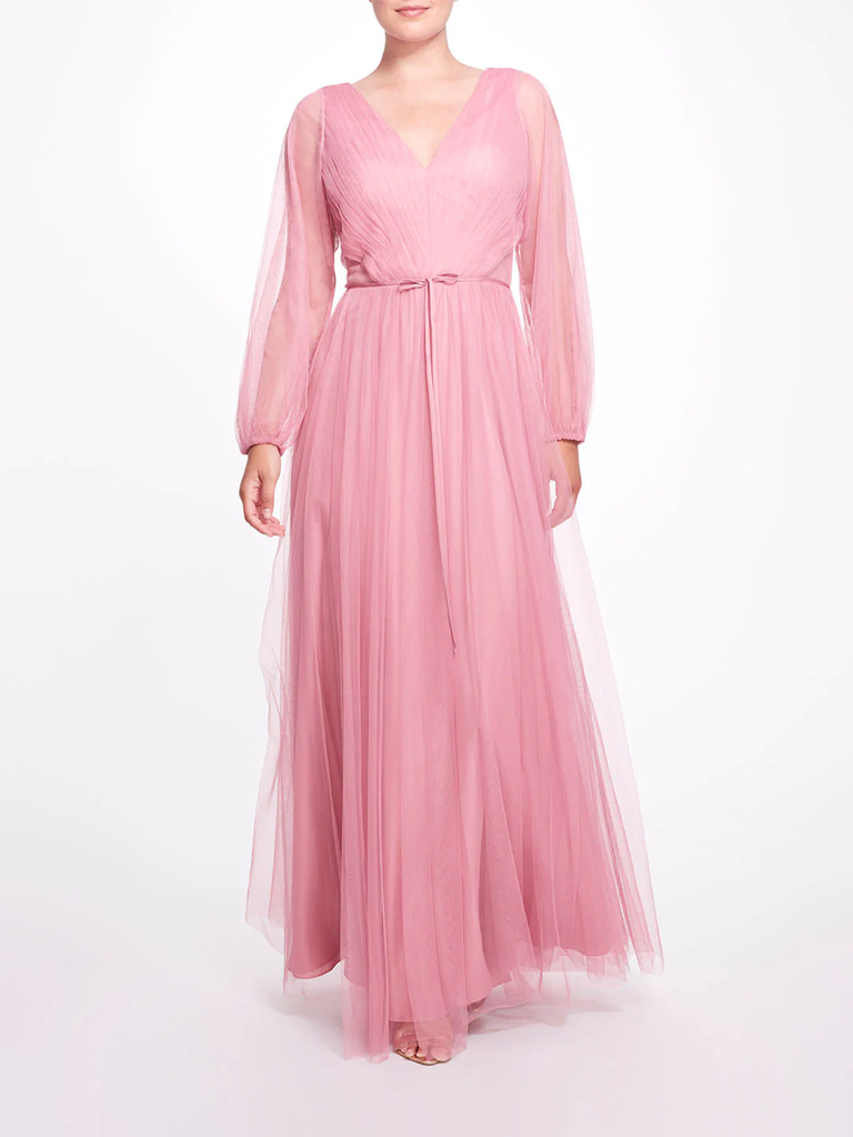 A model wears this light pink mother of the bride gown with a V-neck and tulle skirt.