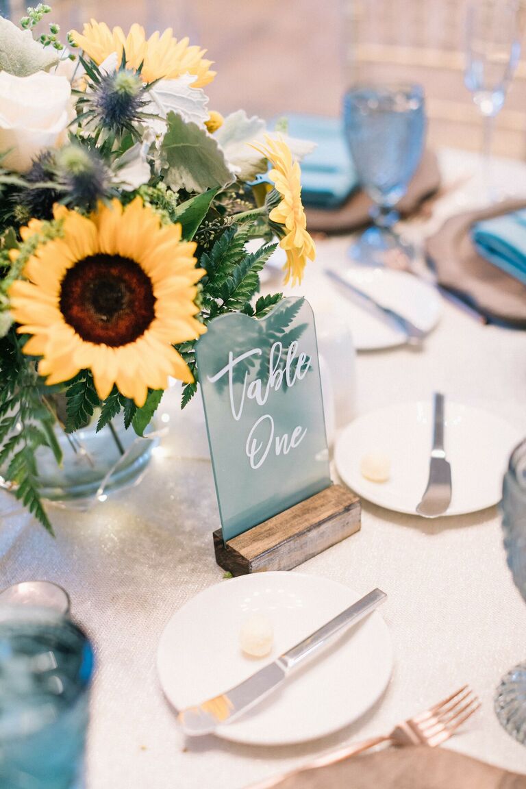 Sunflower centerpiece and blue seagrass table number