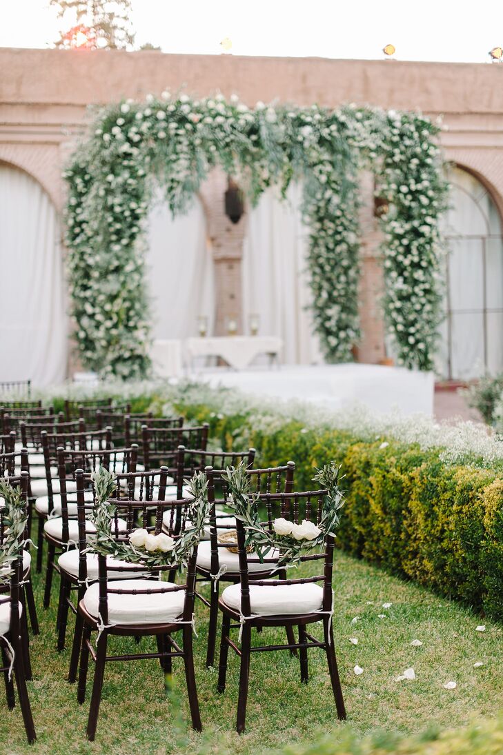 Moroccan lanterns lined the aisle, which was covered in a white capret to match the linen chair cushions.