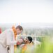 Bride in A-Line Gown, Groom in White-and-Black Suit in Recessional Celebrating, Bubbles