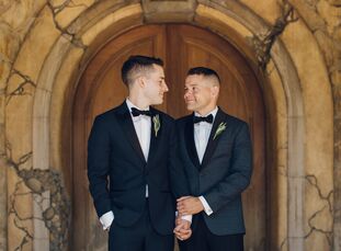 As lovers of wine, Andrew (left) and Kevin decided to wed at Sunstone Winery in Santa Ynez, California. The Tuscan-style venue inspired the neutral, m