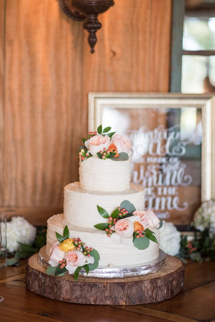 Morgan and Park’s three-tier cake with cinnamon, chocolate and vanilla flavoring was iced in vanilla buttercream frosting and decorated with flowers that complemented the bouquets. Next to the cake, a hand-painted sign read, ”Whatever our souls are made of, his and mine are the same."