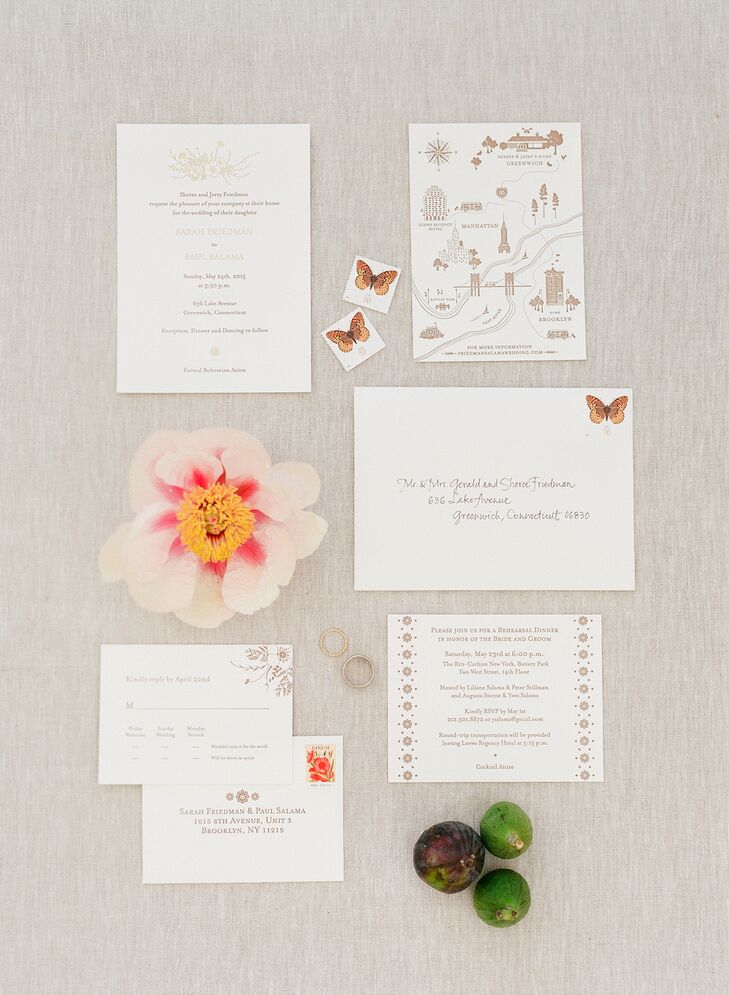 Loose bouquet illustrations and butterflies accented Sarah and Paul's cooper and gold invitations.