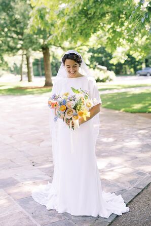 Bride in Short-Sleeved Gown With Long Veil and Colorful Spring Bouquet