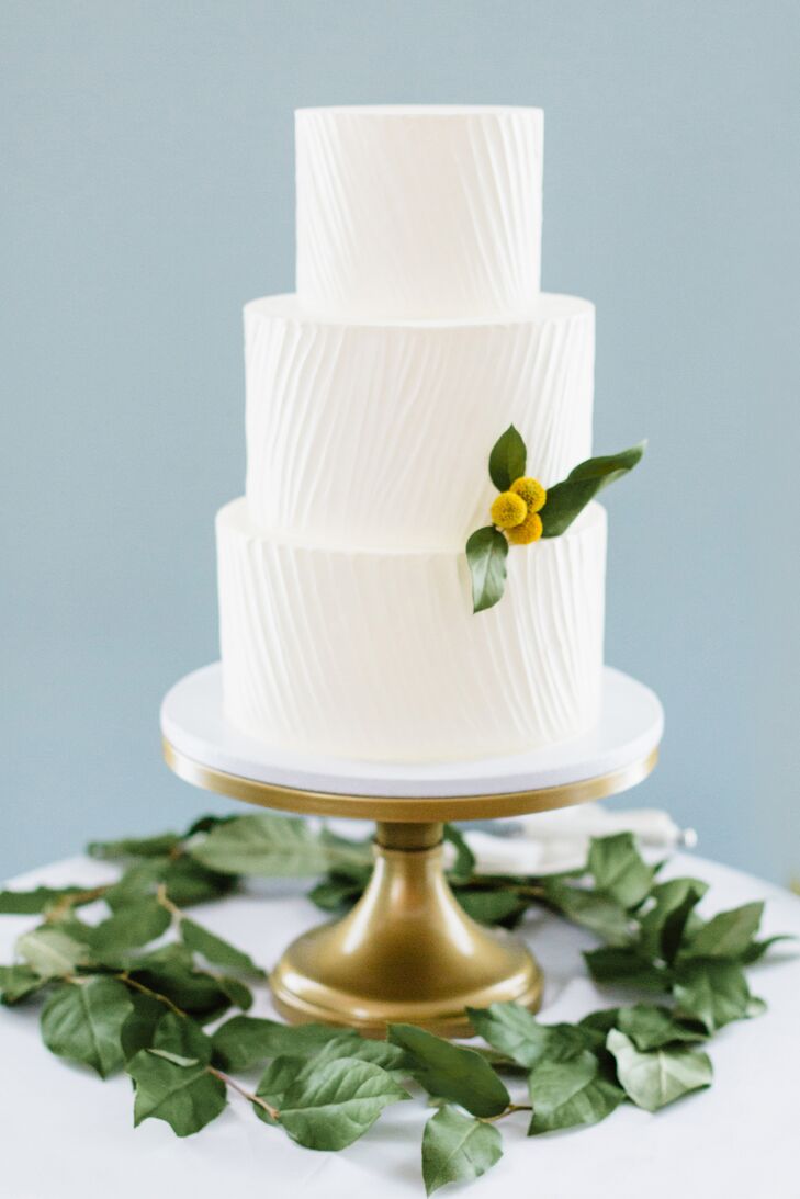 Earth and Sugar bakery crafted Wes and Jay's simple white wedding cake, which was accented with a single yellow billy ball.