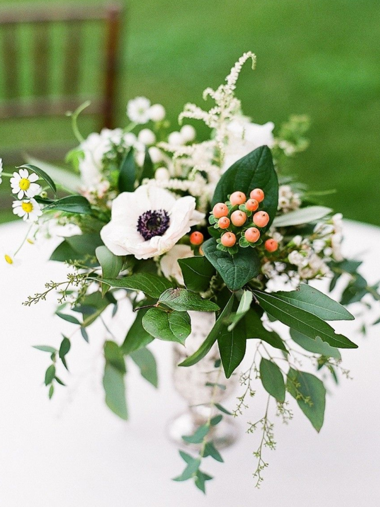 Centerpiece with anemone, hypericum, greenery and astilbe