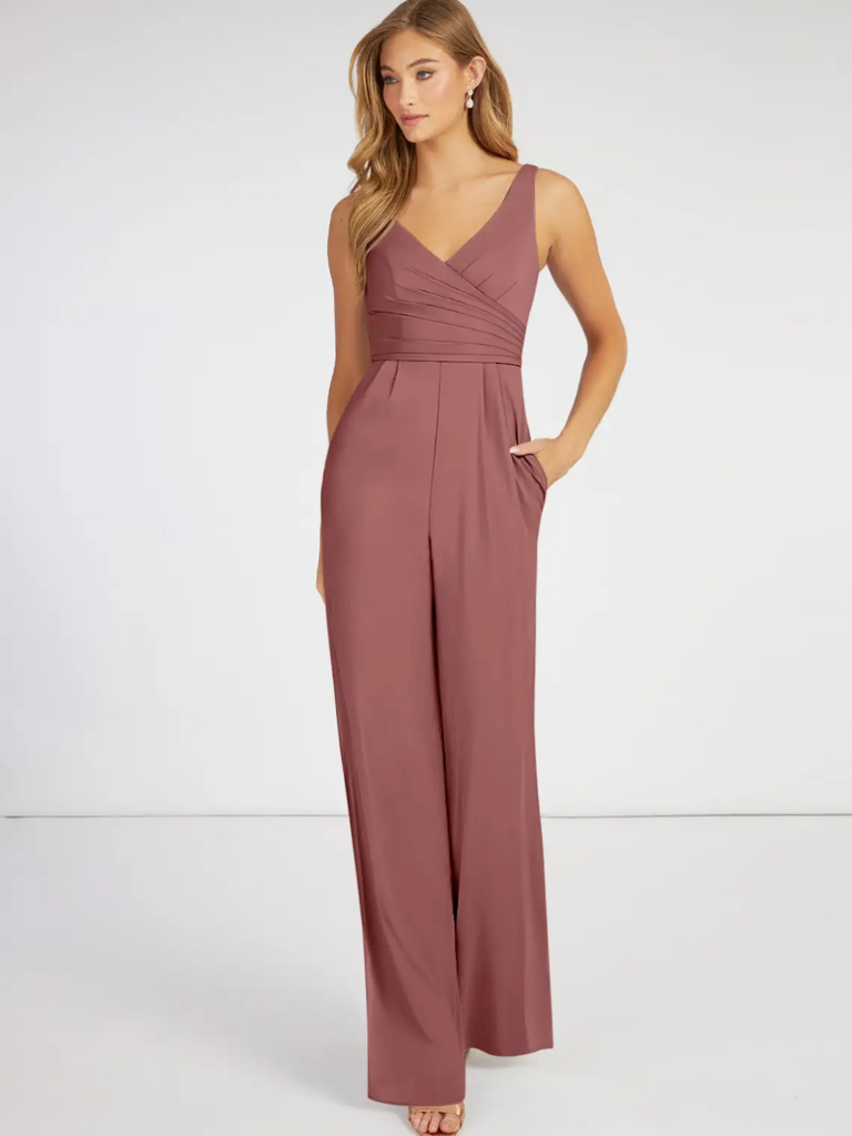 Model wearing a mauve jumpsuit with pockets and a v-neckline