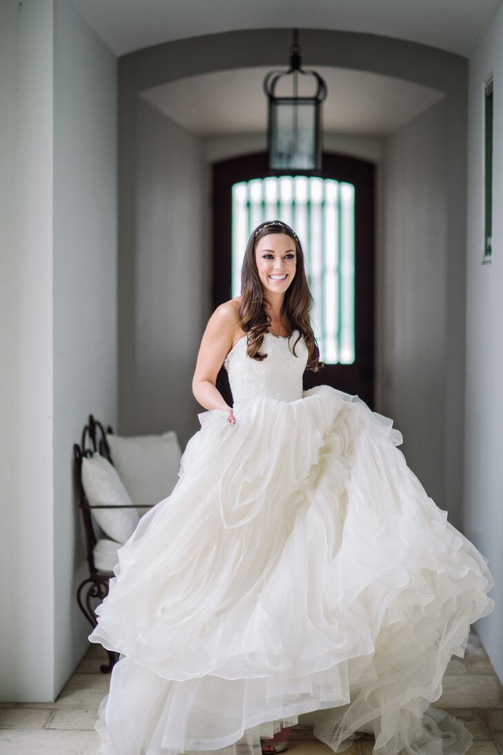 Blakeney wore a custom couture ivory Augusta Jones ball gown with a lacy bodice and layered organza skirt, which she accessorized with a Jenny Packham crystal headpiece, a Toni Federici chapel-length veil and Jimmy Choo wedges.