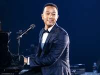 John Legend performing at piano
