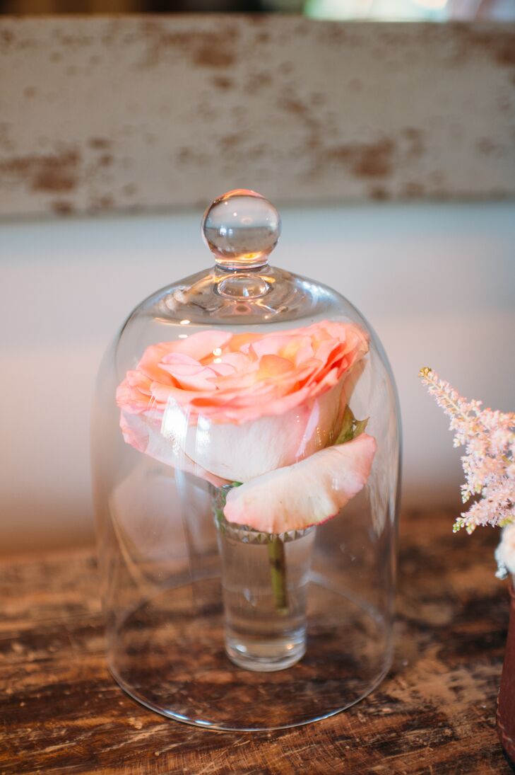 Thinking “Beauty and the Beast?” We are too. Along with little Mickey Mouse details hidden throughout their reception, the couple made subtle nods to their Disney inspiration with memorable details. Along with this covered rose, vintage posters reminiscent of Disney theme park rides also marked their tables.