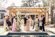 With just 30 days of planning, Caroline and Gene pulled together an elegant, intimate backyard wedding with a neutral color palette of dusty rose and 