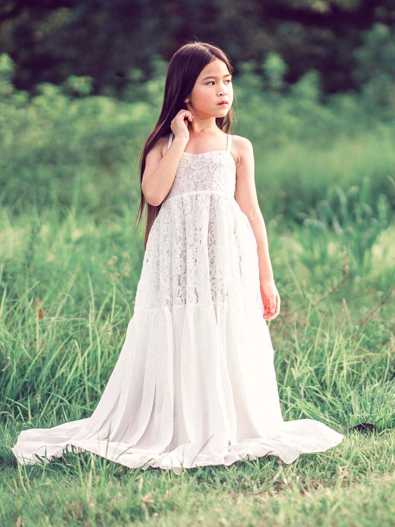 young girl wearing long white lace dress