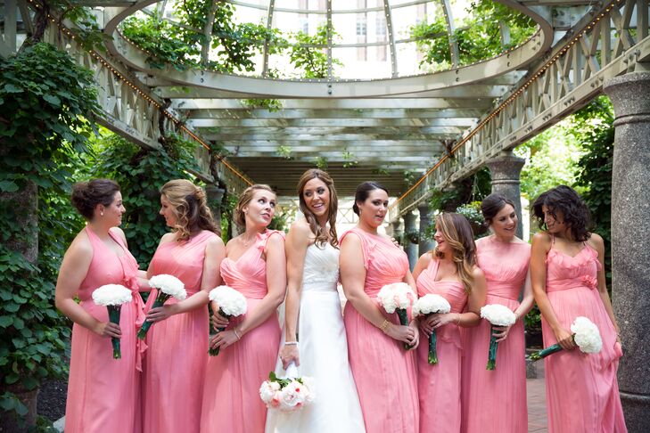 The bridesmaids wore long coral pink dresses.