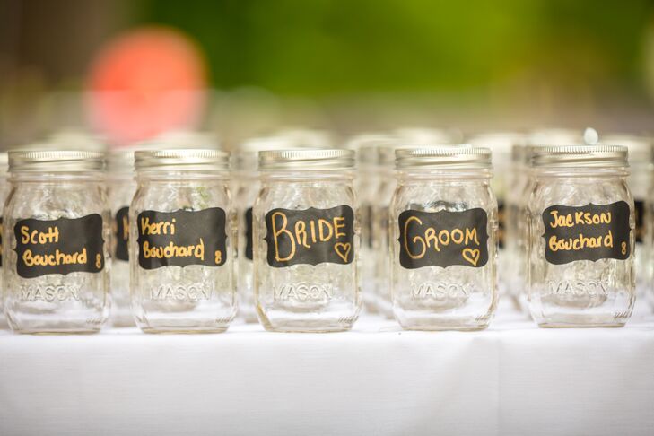 Guests found their seating assignments handwritten in gold ink on mason jars.