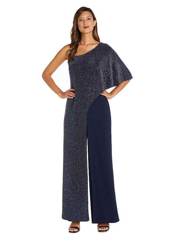 Model wearing a sparkly capelet jumpsuit with a thin strap and one three-quarter sleeve