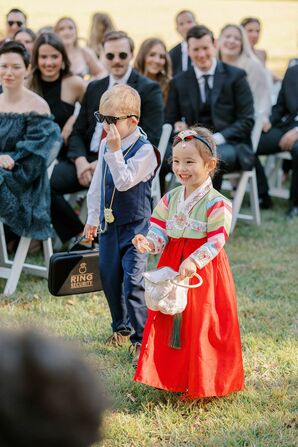 Flower Girl in Traditional Korean Attire and Ring Bearer in Suit With Briefcase