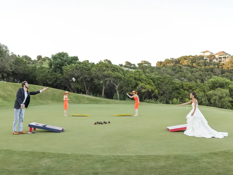 Bride and groom and guests playing corn hole on golf course at river place country club wedding venue in austin, texas
