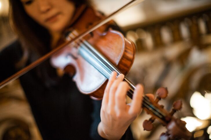Kathy wanted to match her theme and decor to match the grand architecture of the venue. Their classy setting and black tie dress code were tied together by the live music of a classical violinist during the ceremony.