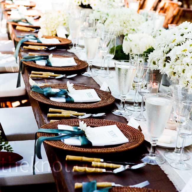 Guests sat at a mix of round and rectangular tables at the reception. All were decorated with white blooms, including peonies and daises, arranged in galvanized flowerpots for a clean, fresh look.