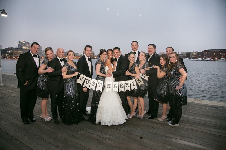 The bridesmaids wore Adrianna Papell black dresses with cap sleeves and silver sequins.  The two maids of honor, the brides sisters, wore a long version while the other bridesmaids wore a short version. rnrnRandy wore a tuxedo designed for him by Tom James.  He also had a 1920s pocket watch and chain that I got him as a wedding gift.  All the groomsmen wore black tuxedos and their groomsmen gifts were pocket watches.rn