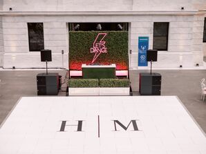 DJ Booth With Neon Sign Beside Monogram Dance Floor
