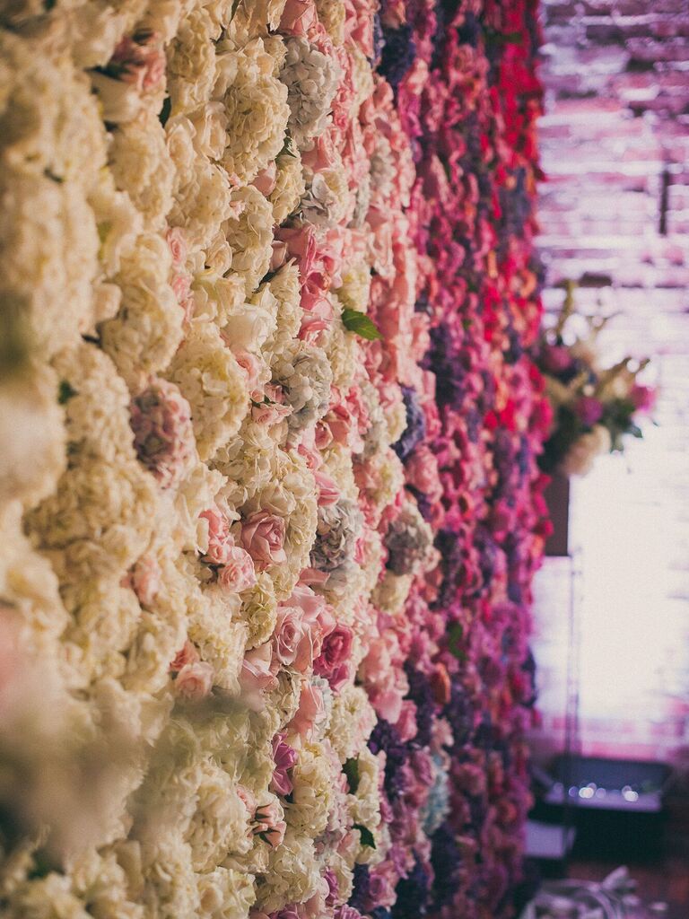 Ombré purple, pink and white wedding flower wall. 
