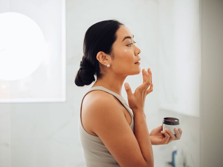 Woman applying skincare products getting rid of acne fast