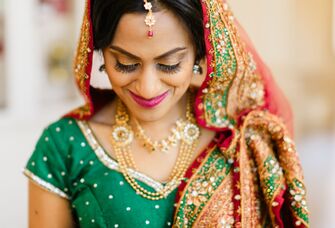 Indian bride wears beautiful gold jewelry. 