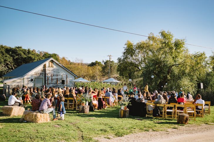 Outdoor Ranch Ceremony, Wooden Chairs and Hay Bales Facing Towering Tree