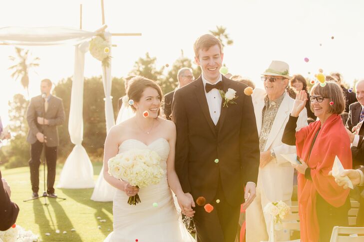 For a fun twist on the traditional recessional, the bride and groom handed out small bags of pom poms. These bright craft store goodies were a fun way to congratulate the newlyweds and look great in pictures.