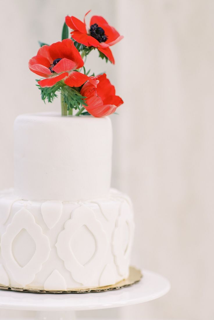cake with red flowers and white fondant