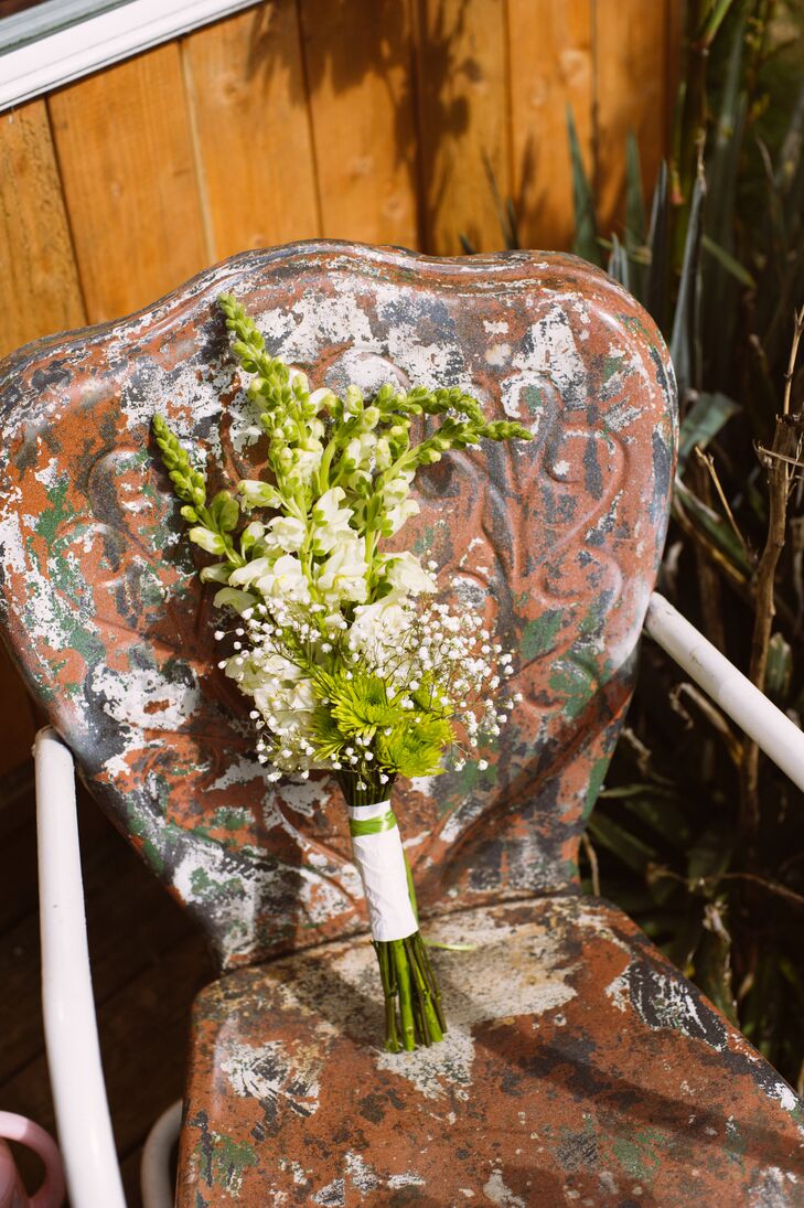 Melissa held a DIY bouquet made by her mother-in-law on the wedding day, which was filled with ivory stock, green button mums and baby's breath, held together with a white wrap around the stems.