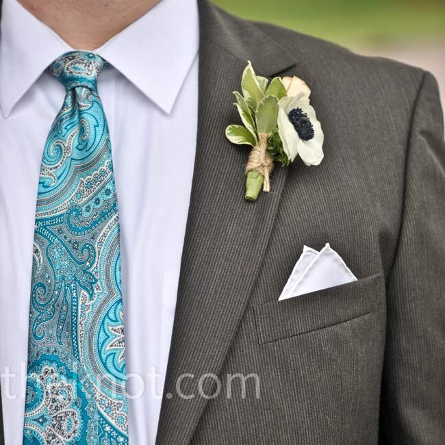 Andrew’s boutonniere was a mini cluster of anemones and rolled pages of a novel.