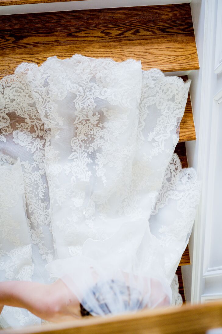 The bride picked a scalloped finger tip veil with a lace trim by BHLDN for the wedding day.