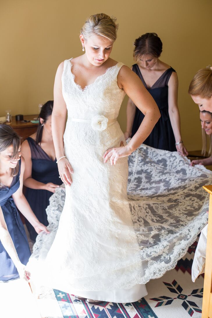 Allyson wore a stunning Monique Lhuillier fit-and-flare gown with a soft alençon lace overlay and v-shaped neckline. She trimmed the gown's lining to floor-length so that the lace train would reveal the bright green grass as she walked down the aisle.rn