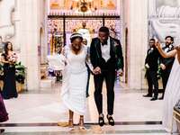 Bride and groom jumping the broom after wedding ceremony