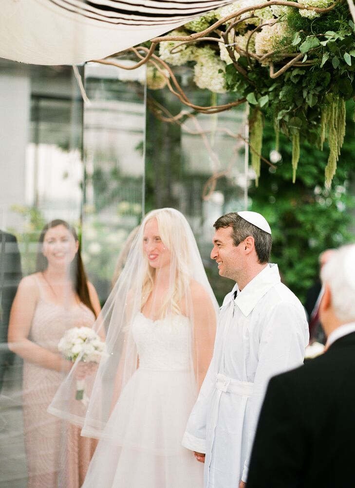 The festivities unfolded with a traditional Jewish ceremony on the roof of Studio 450 in New York, New York, where Mia and Jake exchanged vows under an opulent chuppah draped in ivory roses, green amaranth and eucalyptus. “Under the chuppah we did the seven blessings, and  as Jake stepped on the glass at the end, our friend and rabbi blew the shofar and everyone yelled 'mazel tov!' ” Mia says. A cellist played during the ceremony, heightening the celebration’s sense of romance.