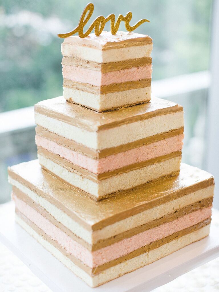 three tier square naked wedding cake with alternating vanilla and strawberry sponge layers